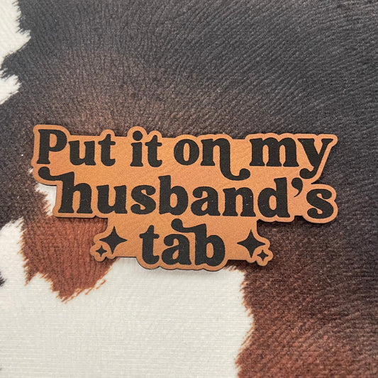 Put it On My Husband's Tab- 3.5" wide x 1.3" tall Leatherette Patch
