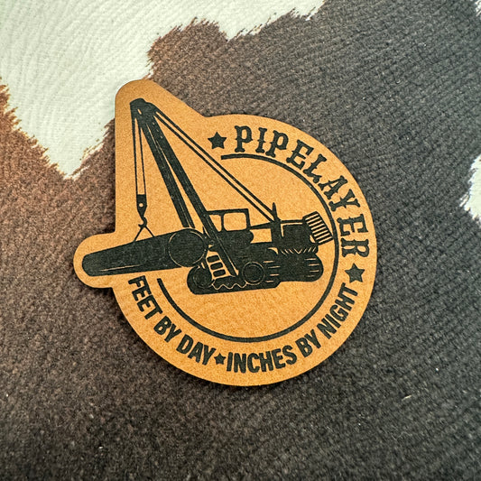 Pipelayer- Feet By Day, Inches By Night- 2.2” wide x 2.4” tall Leatherette Patch